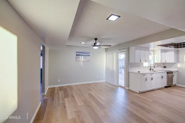 a large kitchen with hardwood floor and a sink