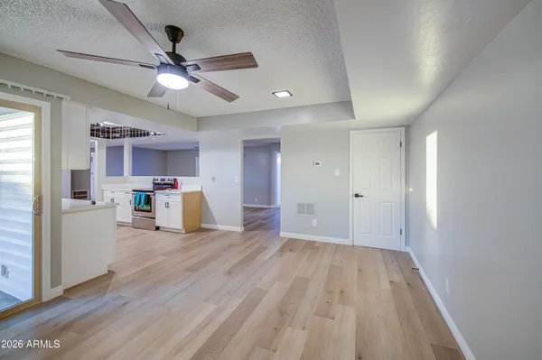 a view of empty room with wooden floor and window