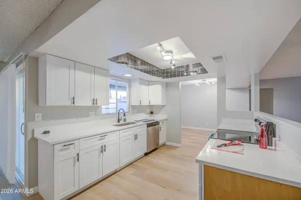a kitchen with a sink stove and cabinets