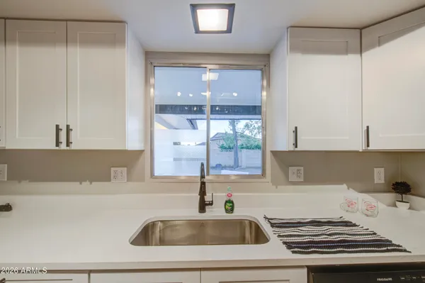 a kitchen with a sink and a refrigerator