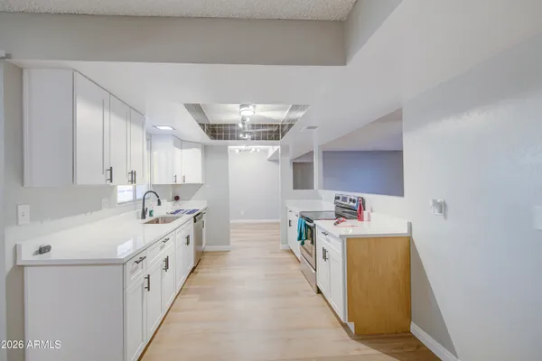 a utility room with cabinets washer and dryer