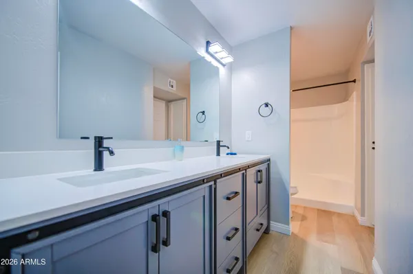 a bathroom with a sink a vanity and a mirror