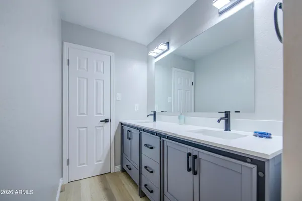 a kitchen with a sink and a mirror