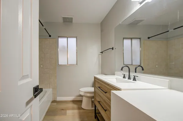 a bathroom with a sink toilet and mirror
