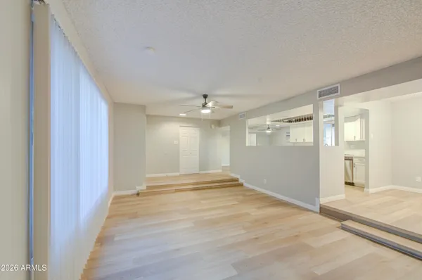 a view of an empty room with glass door