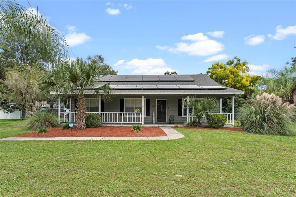 325 West Retta Street De Leon Springs, FL 32130 - Photo 1 of 1 a front view of house with outdoor seating and entertaining space