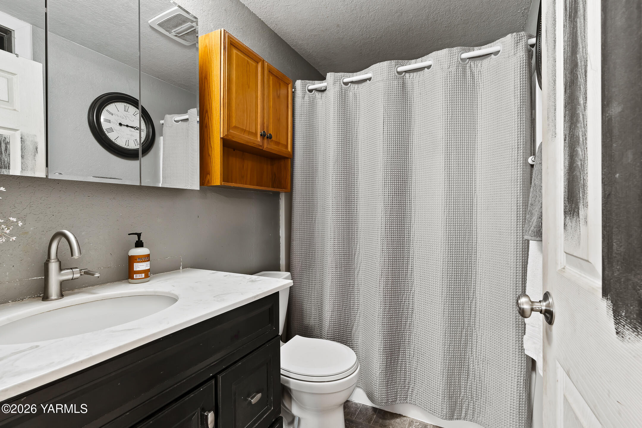 708 Daugherty Place Selah, WA 98942 - Photo 18 of 27 a bathroom with a sink vanity mirror and toilet