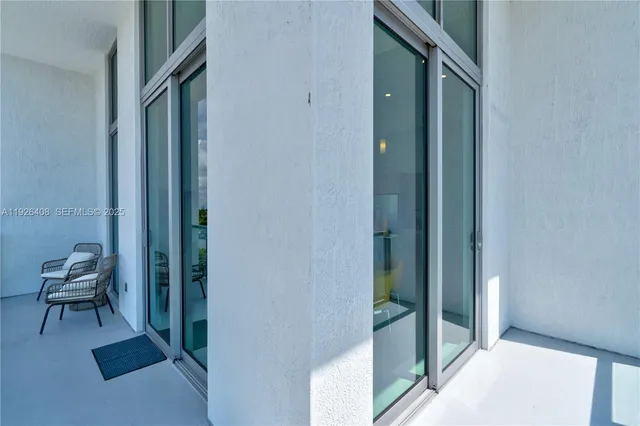 a view of a hallway with seating area