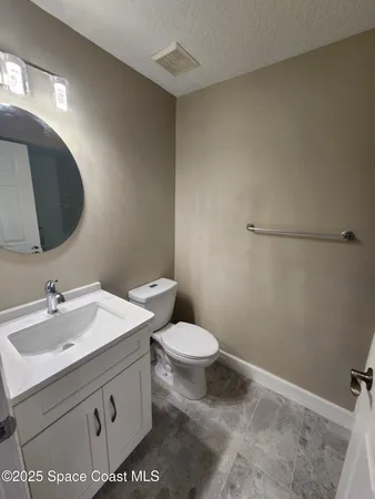 a bathroom with a sink a toilet and mirror