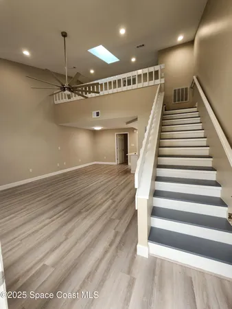 a view of a hallway with stairs