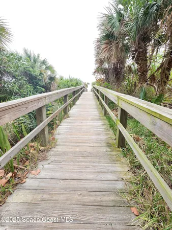 a view of balcony with wooden floor and fence
