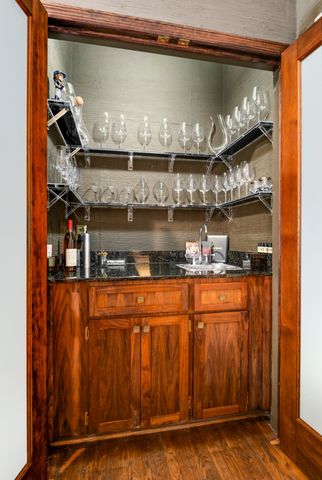 a bathroom with granite countertop a double vanity sink and a window