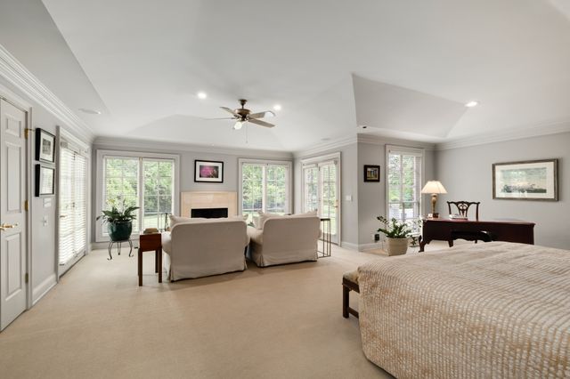 a spacious bathroom with a tub a double vanity sink a mirror and a shower