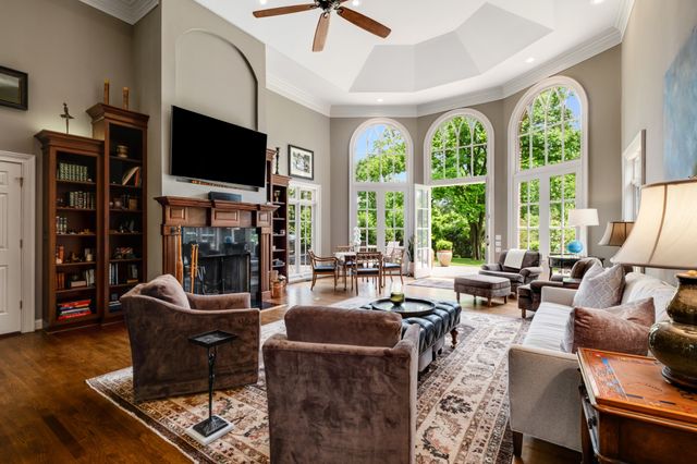 a living room with fireplace furniture and a flat screen tv