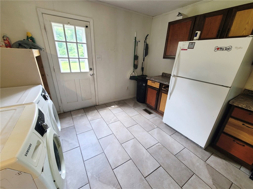 110 Ridgemont Court Greenwood, SC 29649 - Photo 8 of 14 A versatile utility area with durable tile flooring and convenient exterior access.