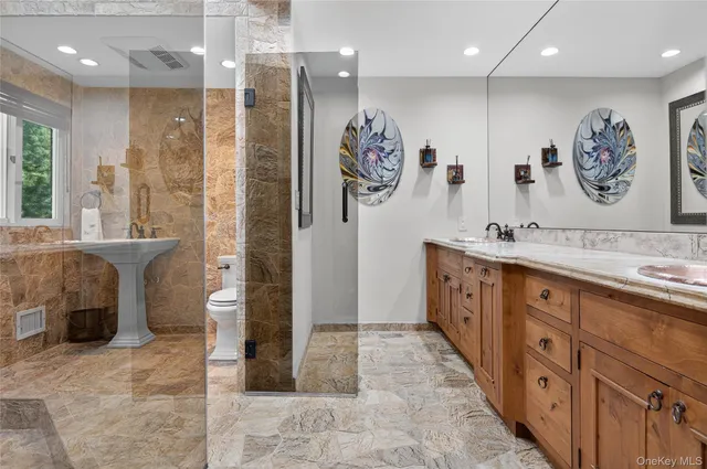 a bathroom with double vanity sink and a shower