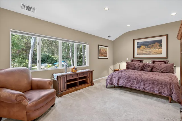 a spacious bedroom with a bed and a large window