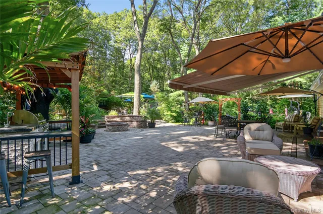 a view of backyard with swimming pool outdoor seating