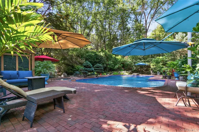 a backyard view with a seating space