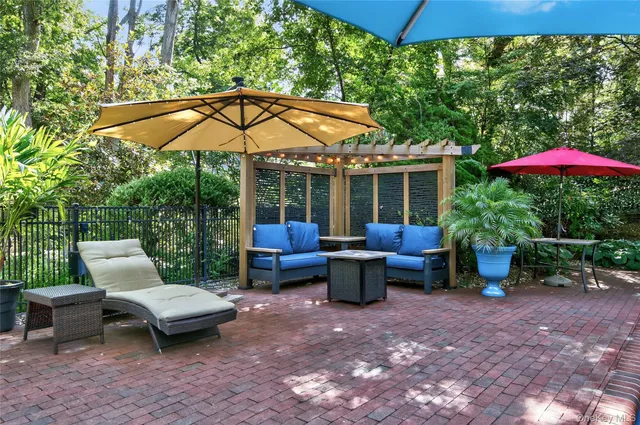 a view of a patio with chairs under an umbrella