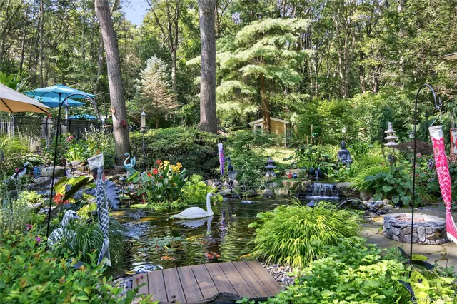 a view of backyard with plants and outdoor seating