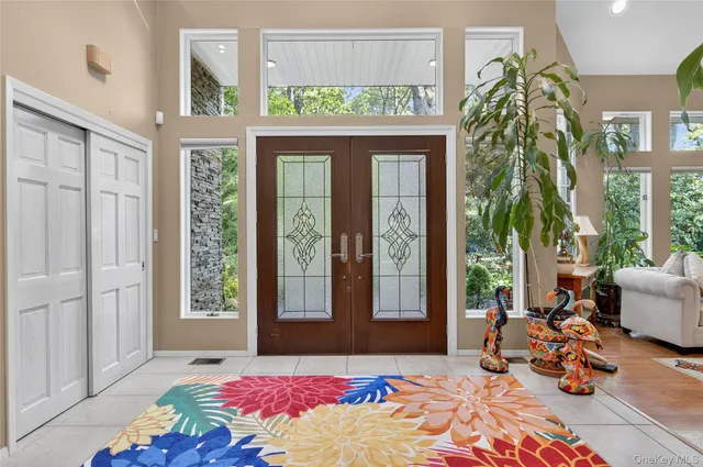 a bedroom with a bed and large windows