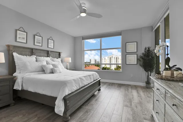 a living room with furniture a lamp and a potted plant