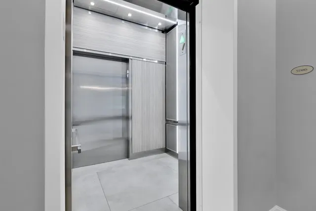 a dining room with furniture a chandelier and window