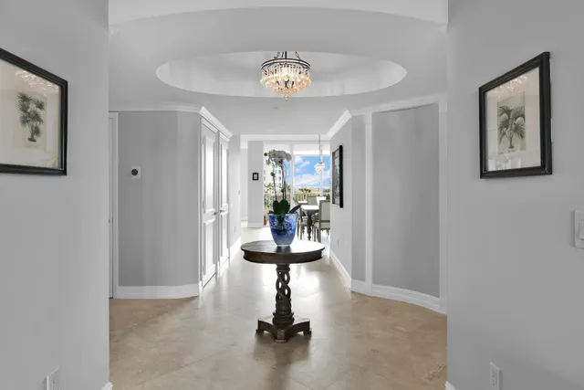 a living room with furniture flat screen tv and large window