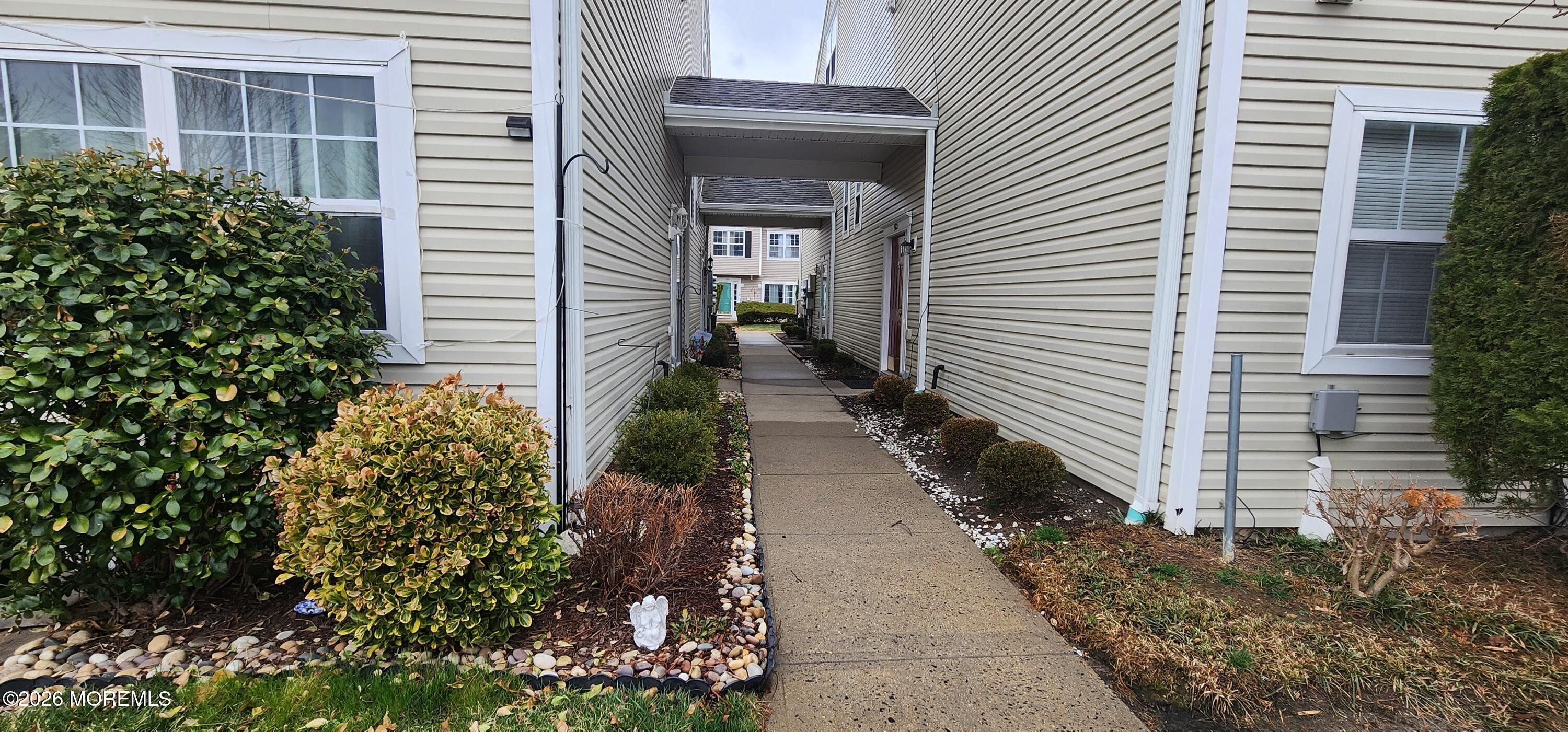 117 Mid Ocean Court, Unit 1000 Howell, NJ 07731 - Photo 1 of 24 a view of a pathway besides a house