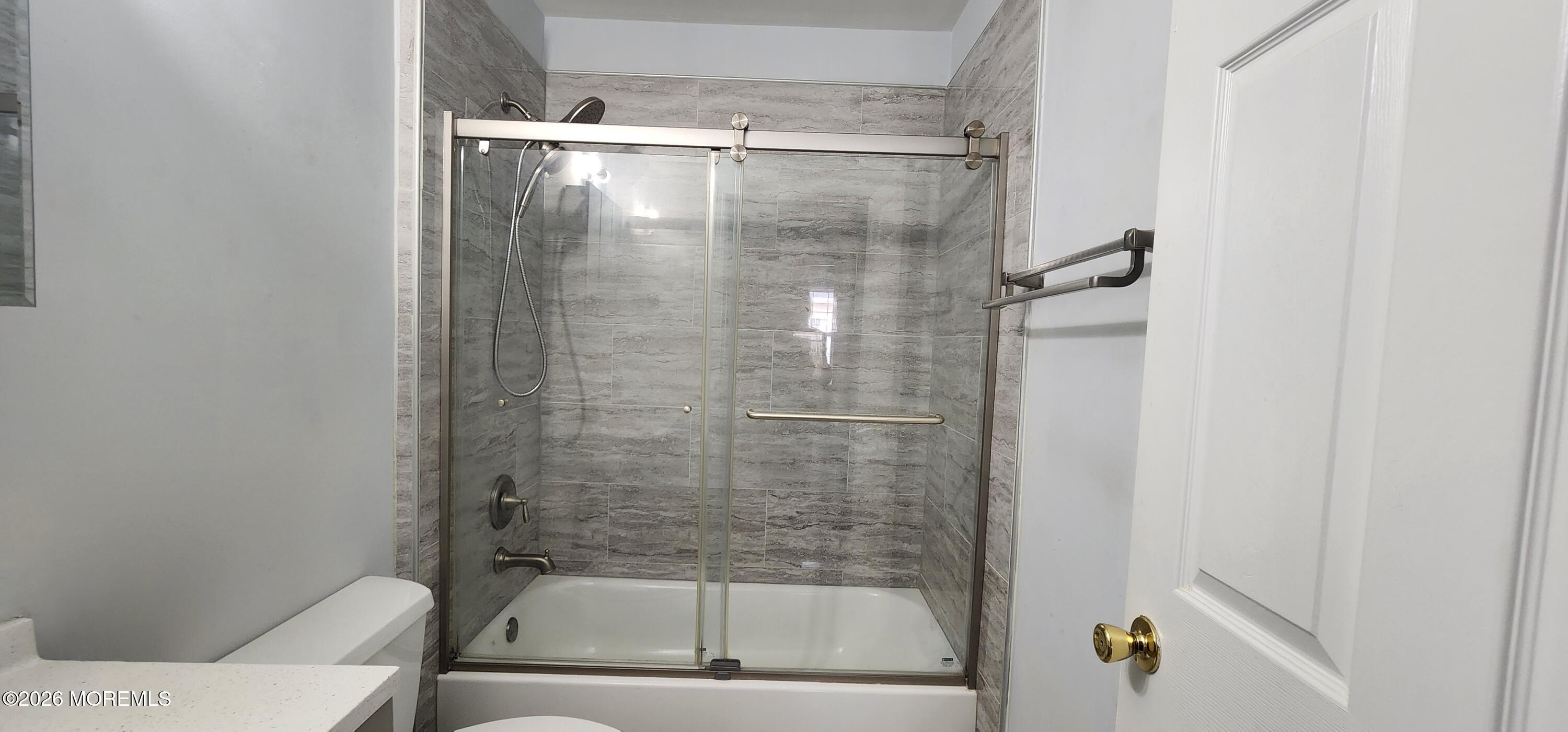 117 Mid Ocean Court, Unit 1000 Howell, NJ 07731 - Photo 12 of 24 a bathroom with a glass shower door