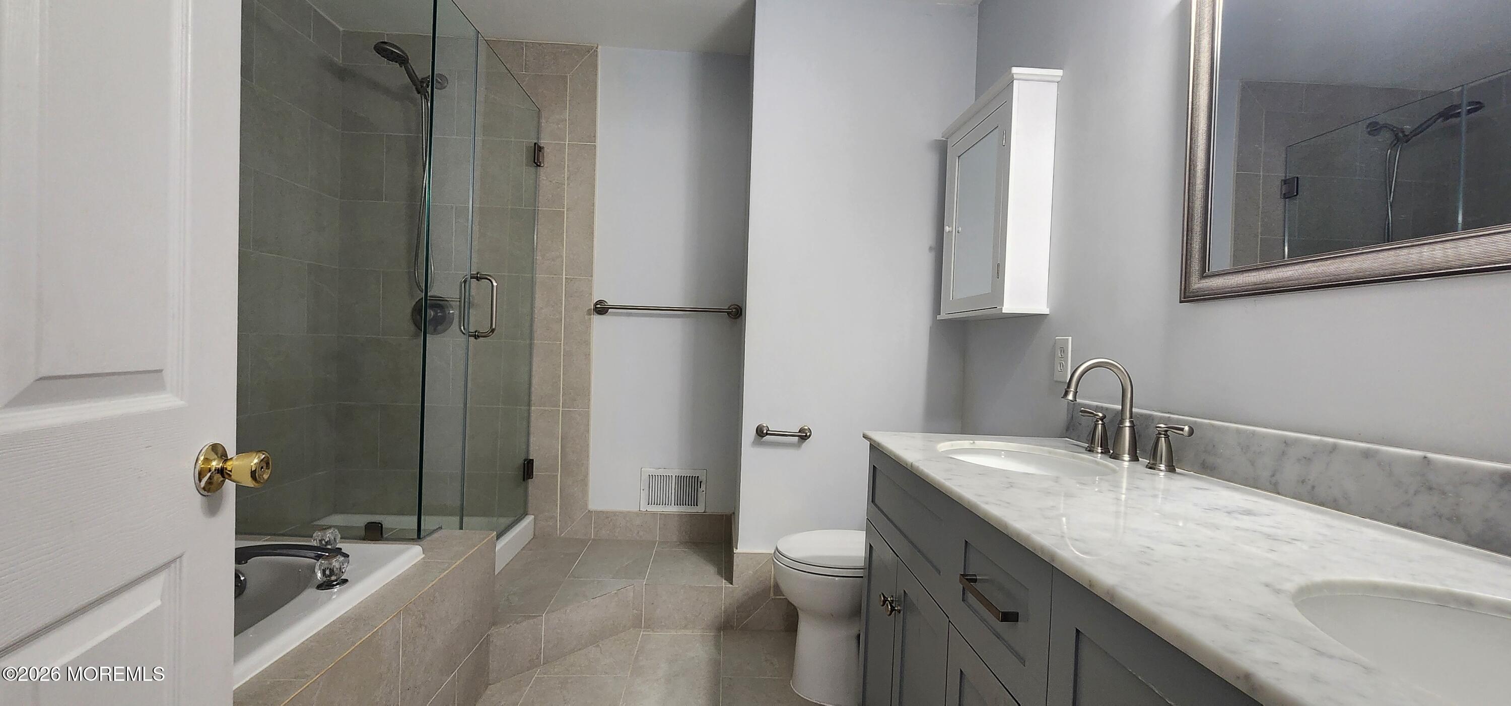 117 Mid Ocean Court, Unit 1000 Howell, NJ 07731 - Photo 18 of 24 a bathroom with a sink and a large mirror