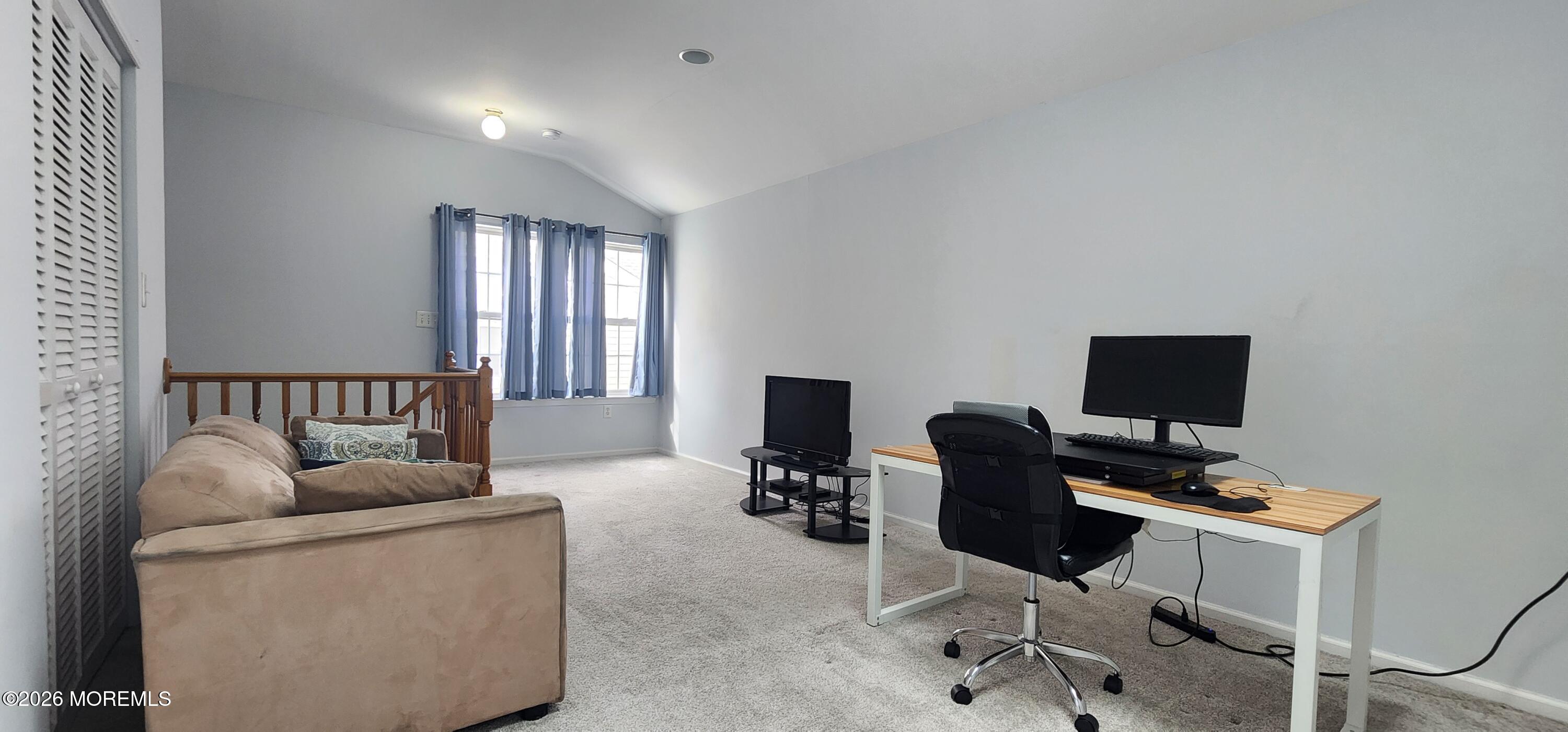 117 Mid Ocean Court, Unit 1000 Howell, NJ 07731 - Photo 22 of 24 a living room with furniture and a flat screen tv