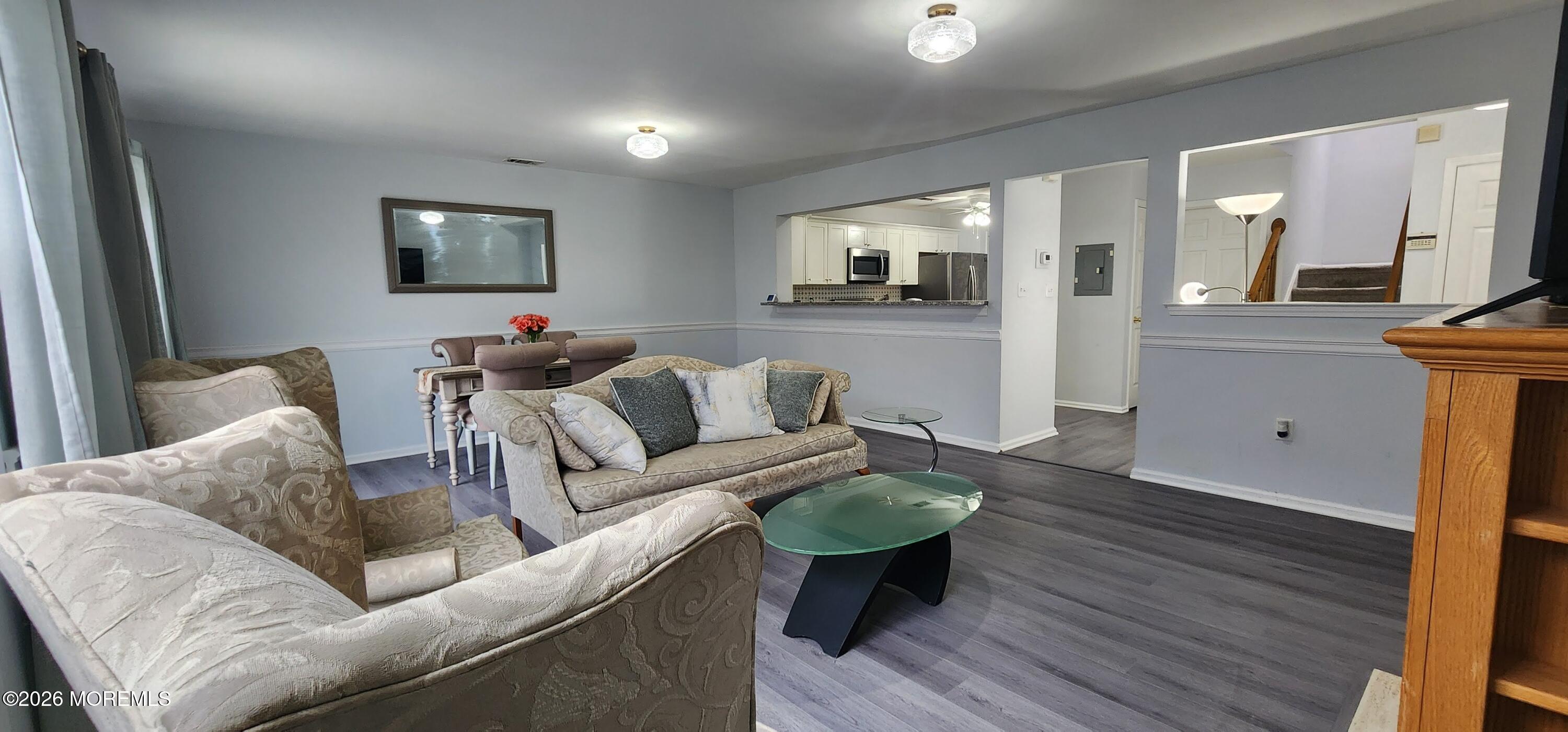 117 Mid Ocean Court, Unit 1000 Howell, NJ 07731 - Photo 4 of 24 a living room with furniture and a wooden floor