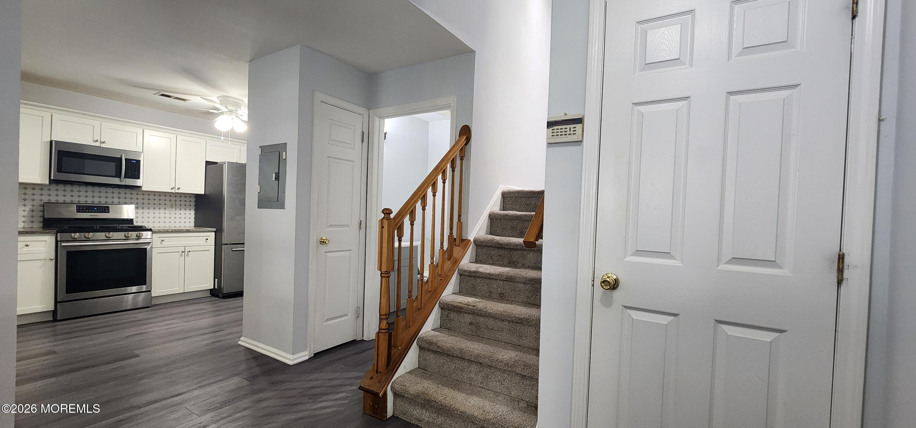 117 Mid Ocean Court, Unit 1000 Howell, NJ 07731 - Photo 9 of 24 a view of a kitchen from the hallway