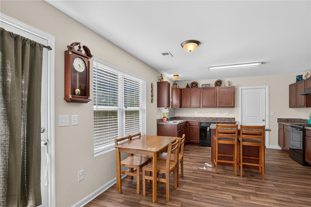 1081 Edenbrooke Circle Anderson, SC 29621 - Photo 15 of 46 A well-lit kitchen and dining area features rich wood cabinetry and ample counter space.
