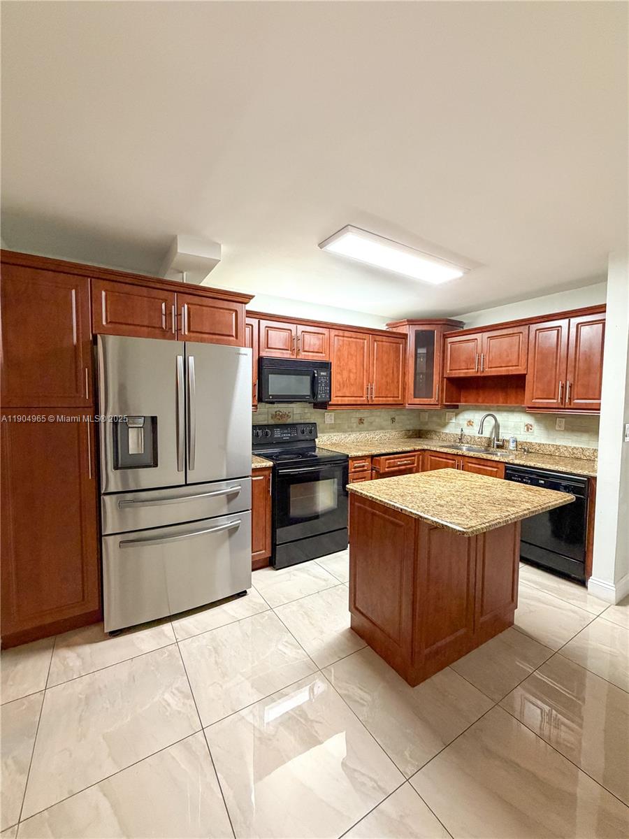 1790 Southwest 122nd Place, Unit 102X Miami, FL 33175 - Photo 2 of 12 a kitchen with stainless steel appliances granite countertop a refrigerator oven a sink and dishwasher
