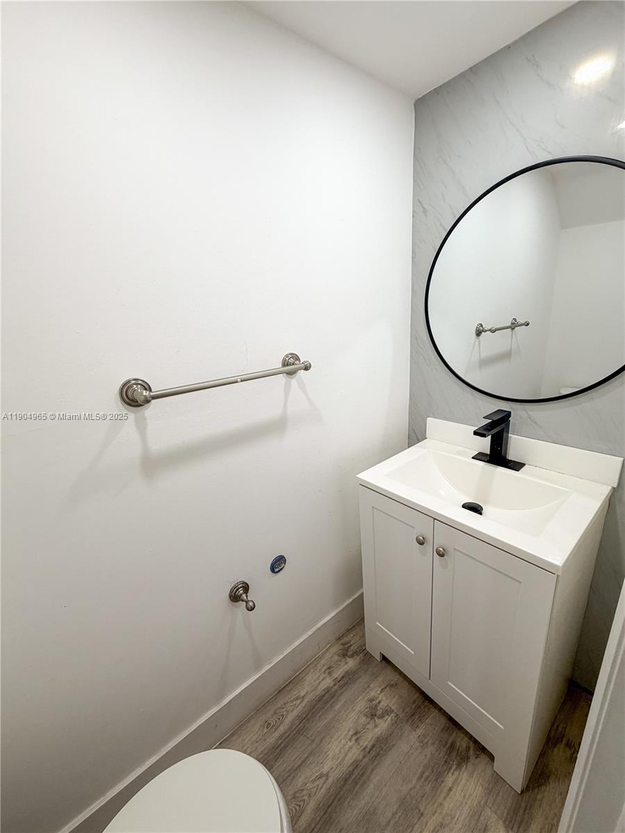 1790 Southwest 122nd Place, Unit 102X Miami, FL 33175 - Photo 3 of 12 a bathroom with a sink and mirror