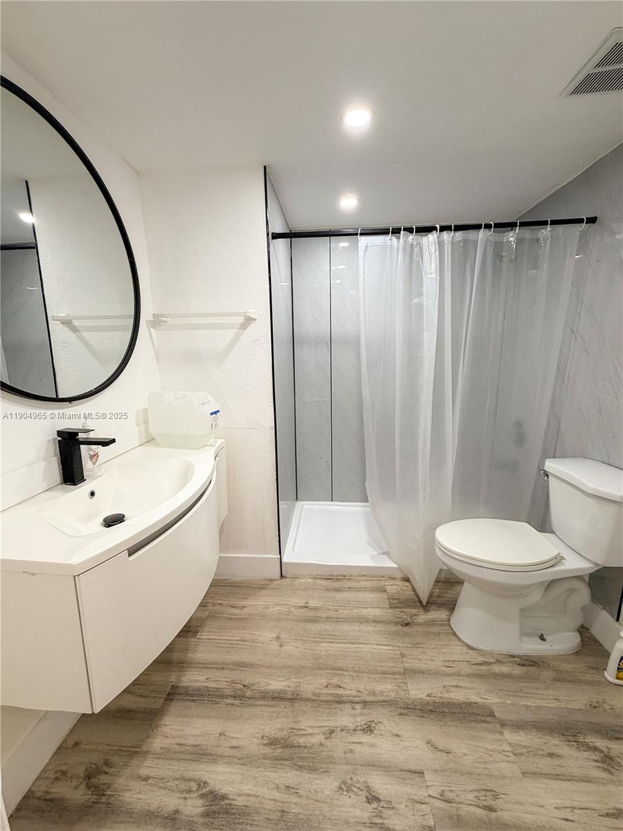 1790 Southwest 122nd Place, Unit 102X Miami, FL 33175 - Photo 7 of 12 a bathroom with a sink toilet and shower