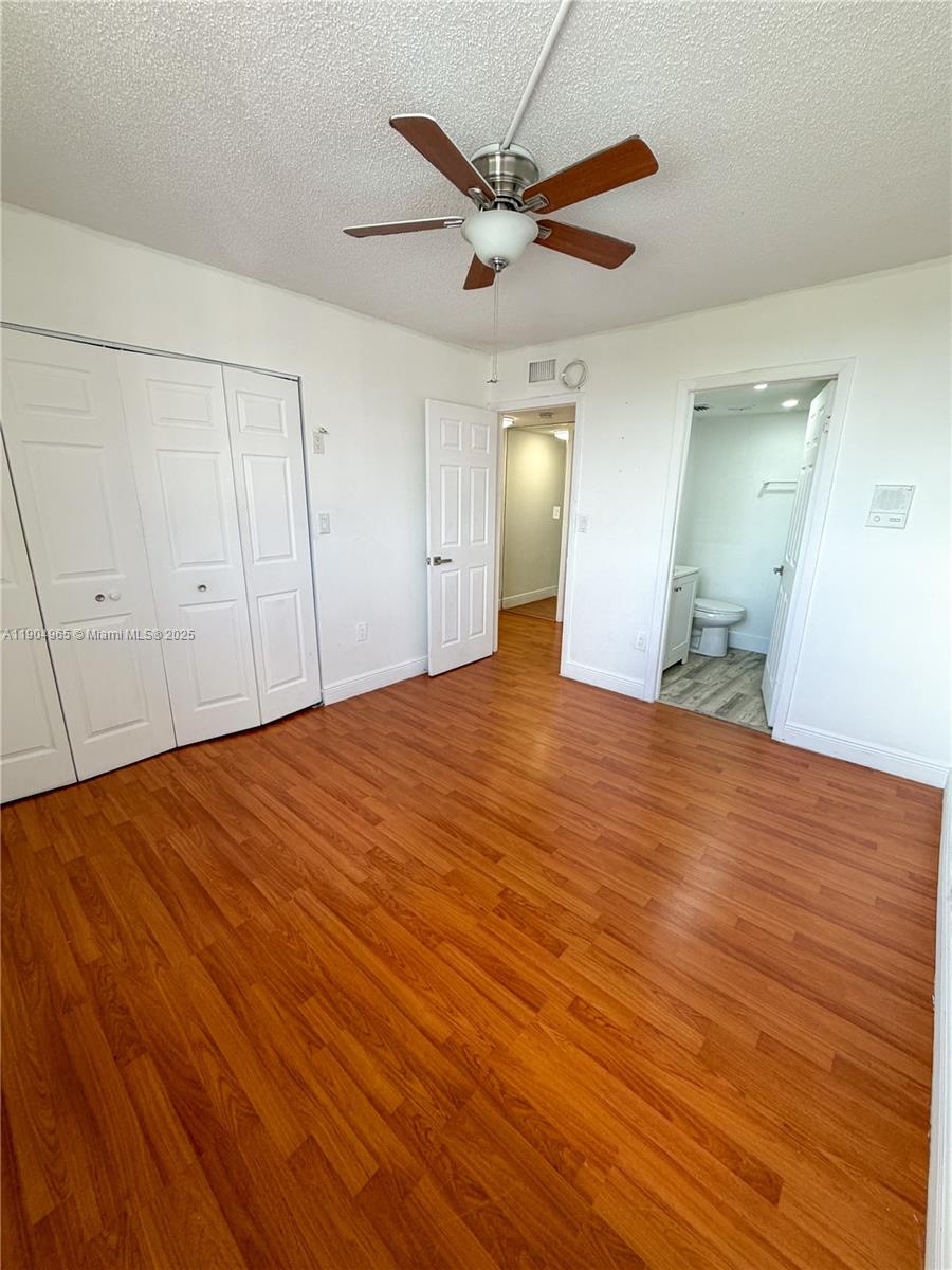 1790 Southwest 122nd Place, Unit 102X Miami, FL 33175 - Photo 8 of 12 a view of a livingroom with a ceiling fan wooden floor and a ceiling fan