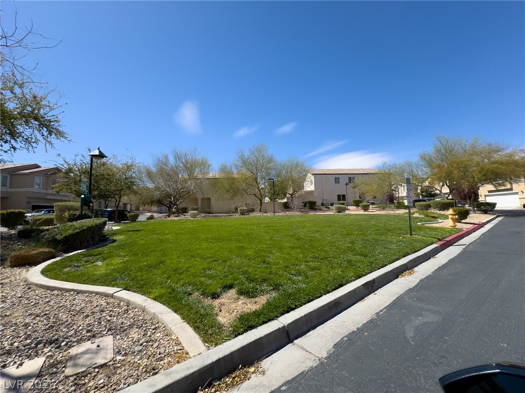 9456 Grandview Spring Avenue Las Vegas, NV 89166 - Photo 43 of 49 A well-maintained community green space offers a serene park-like setting.