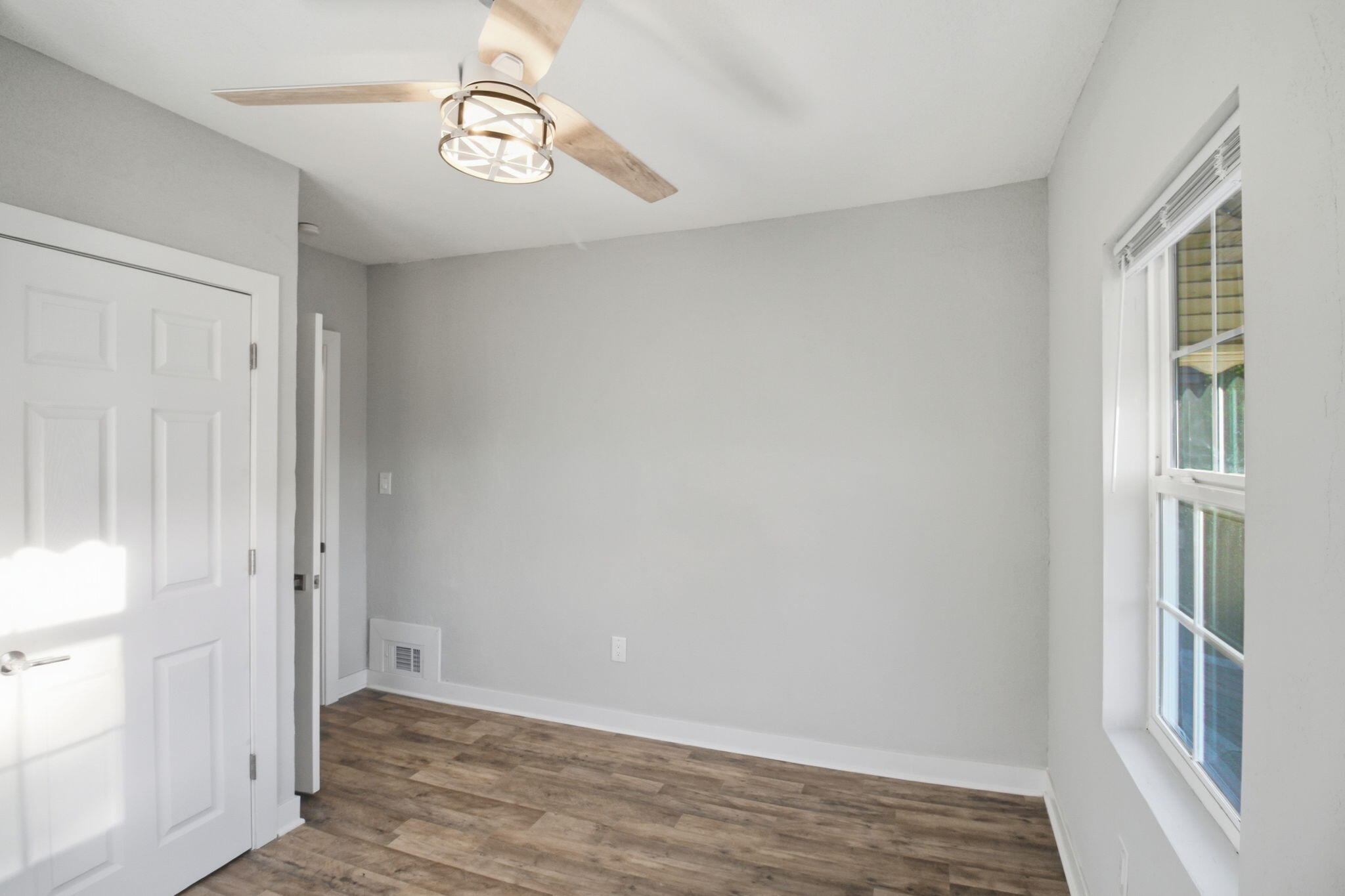 537 Harrison Street Gary, IN 46402 - Photo 11 of 24 a view of an empty room with wooden floor and a window