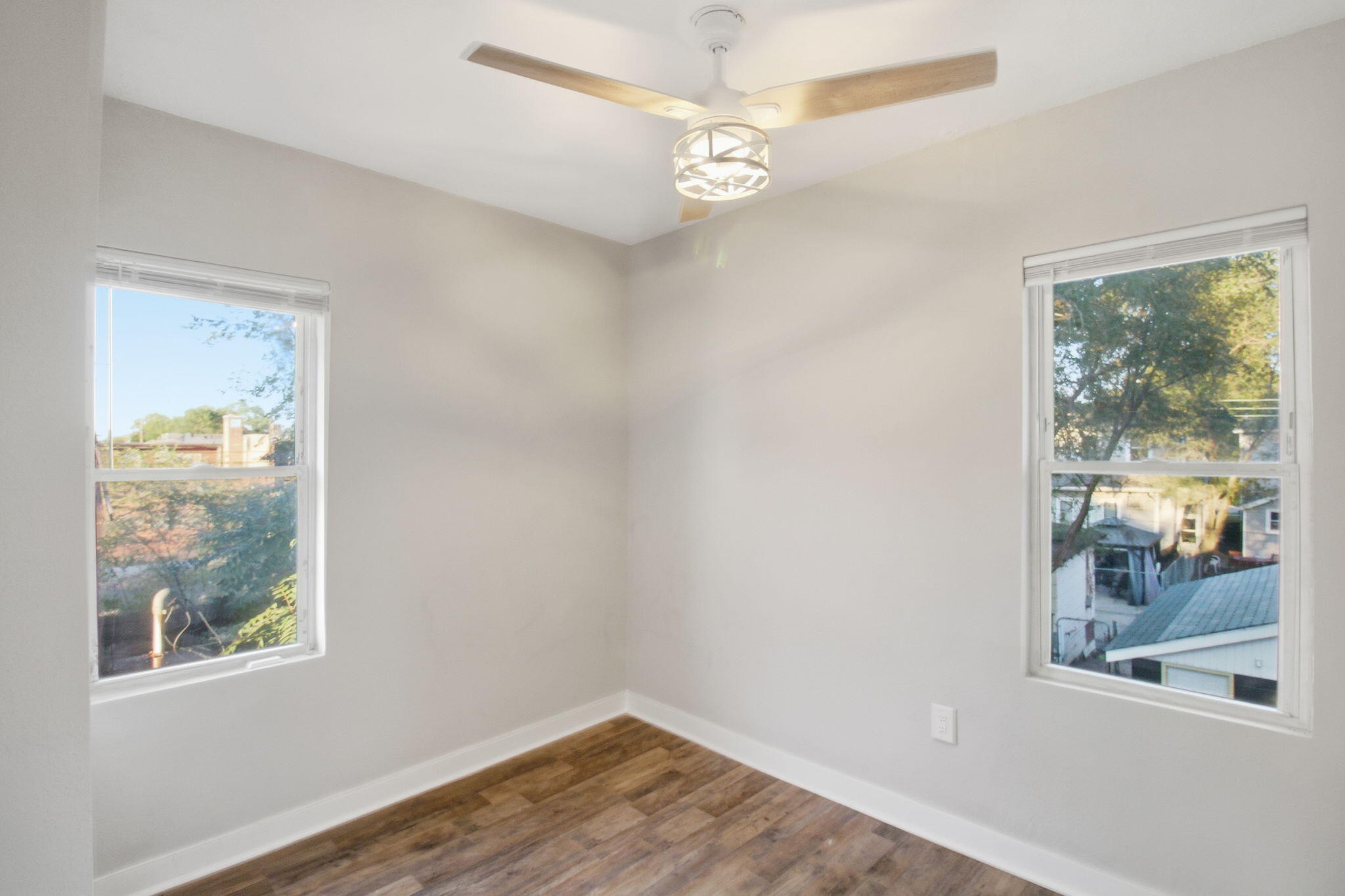 537 Harrison Street Gary, IN 46402 - Photo 16 of 24 an empty room with wooden floor and windows