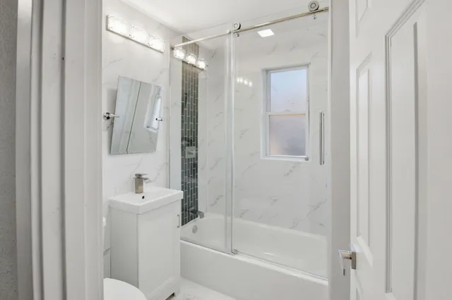 a bathroom with a sink mirror toilet and bathtub
