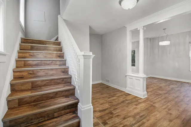 a view of entryway and hall with wooden floor