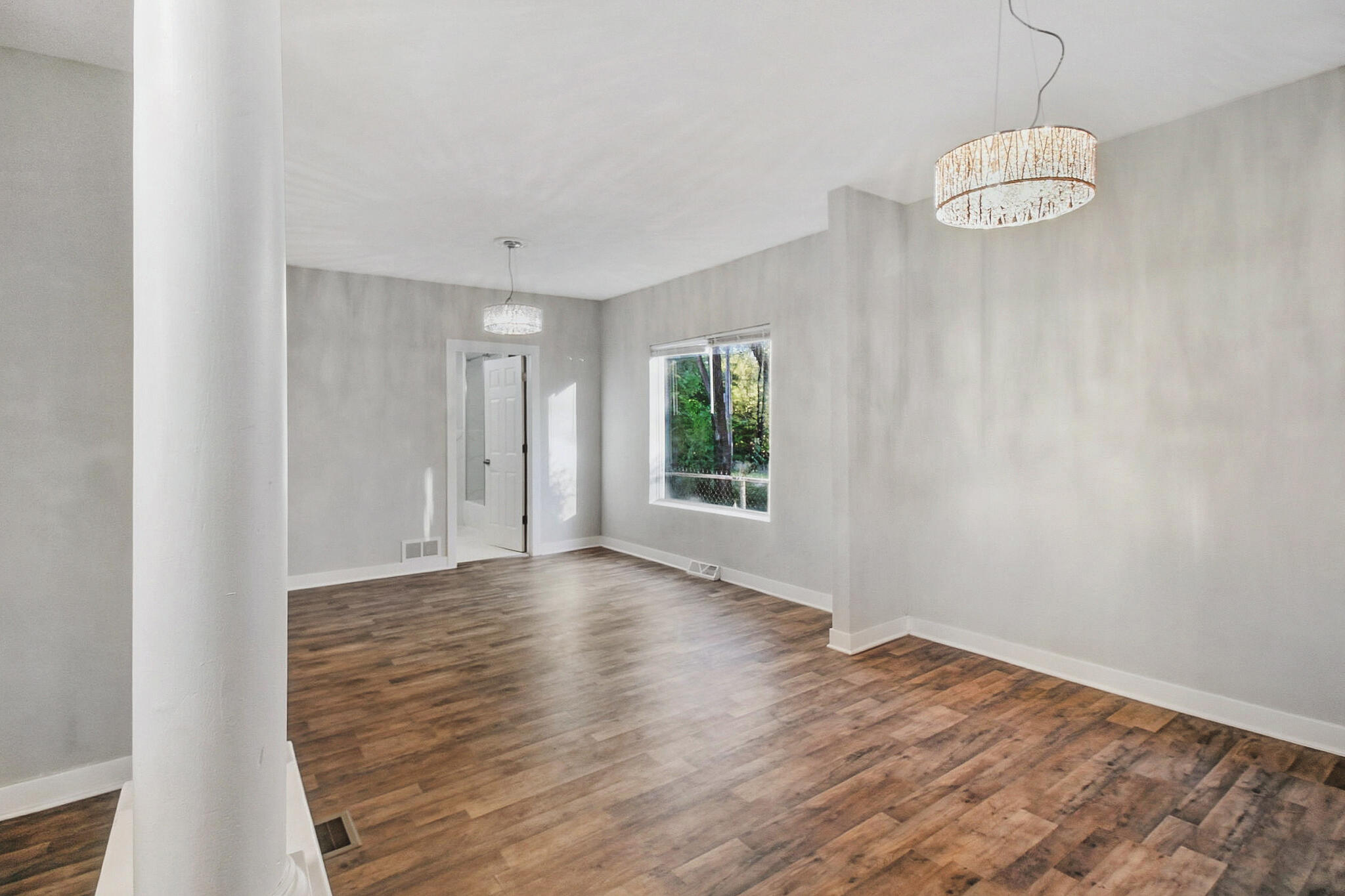537 Harrison Street Gary, IN 46402 - Photo 5 of 24 a view of an empty room with wooden floor and window