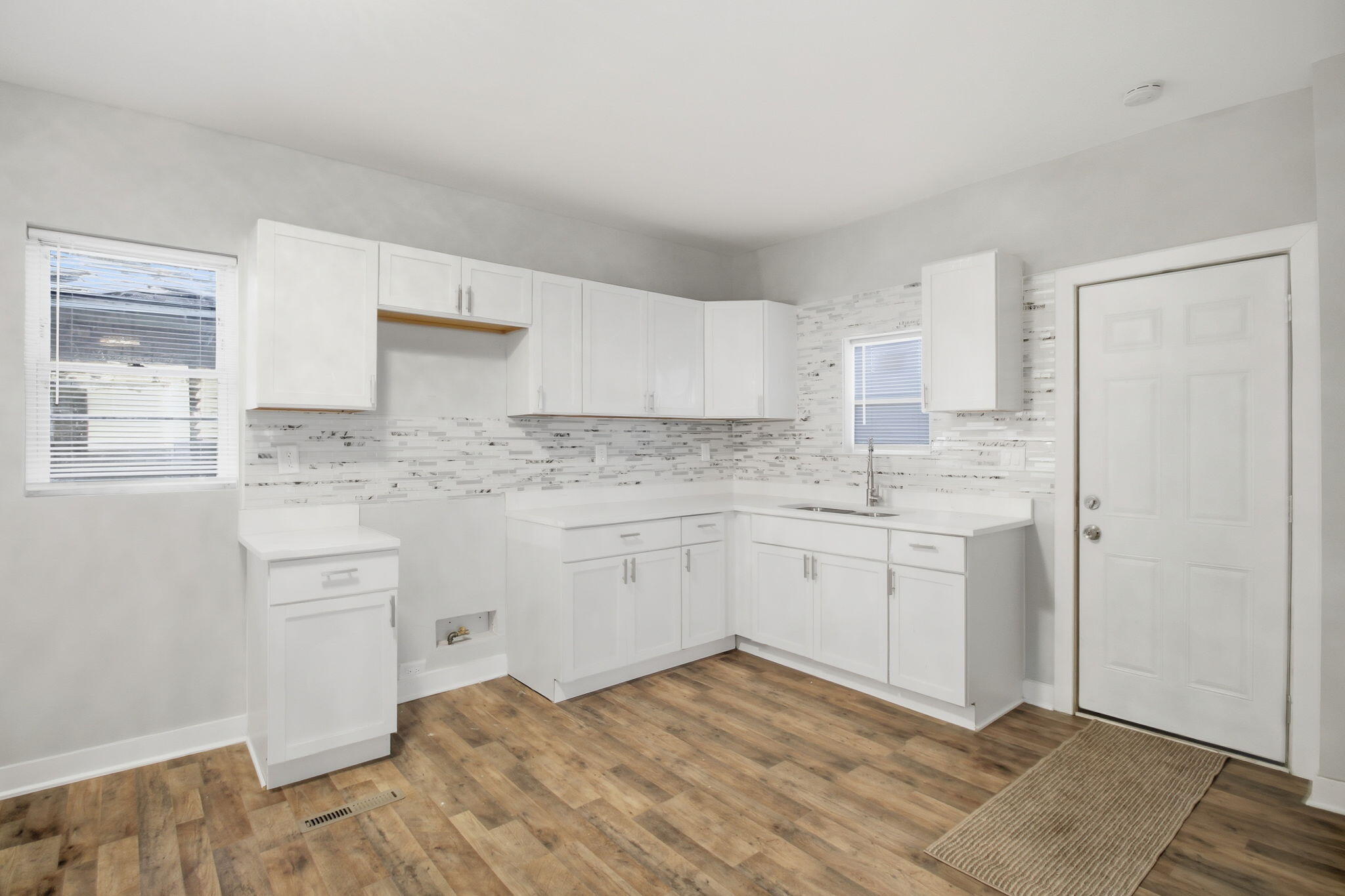 537 Harrison Street Gary, IN 46402 - Photo 8 of 24 a kitchen with granite countertop white cabinets and white appliances