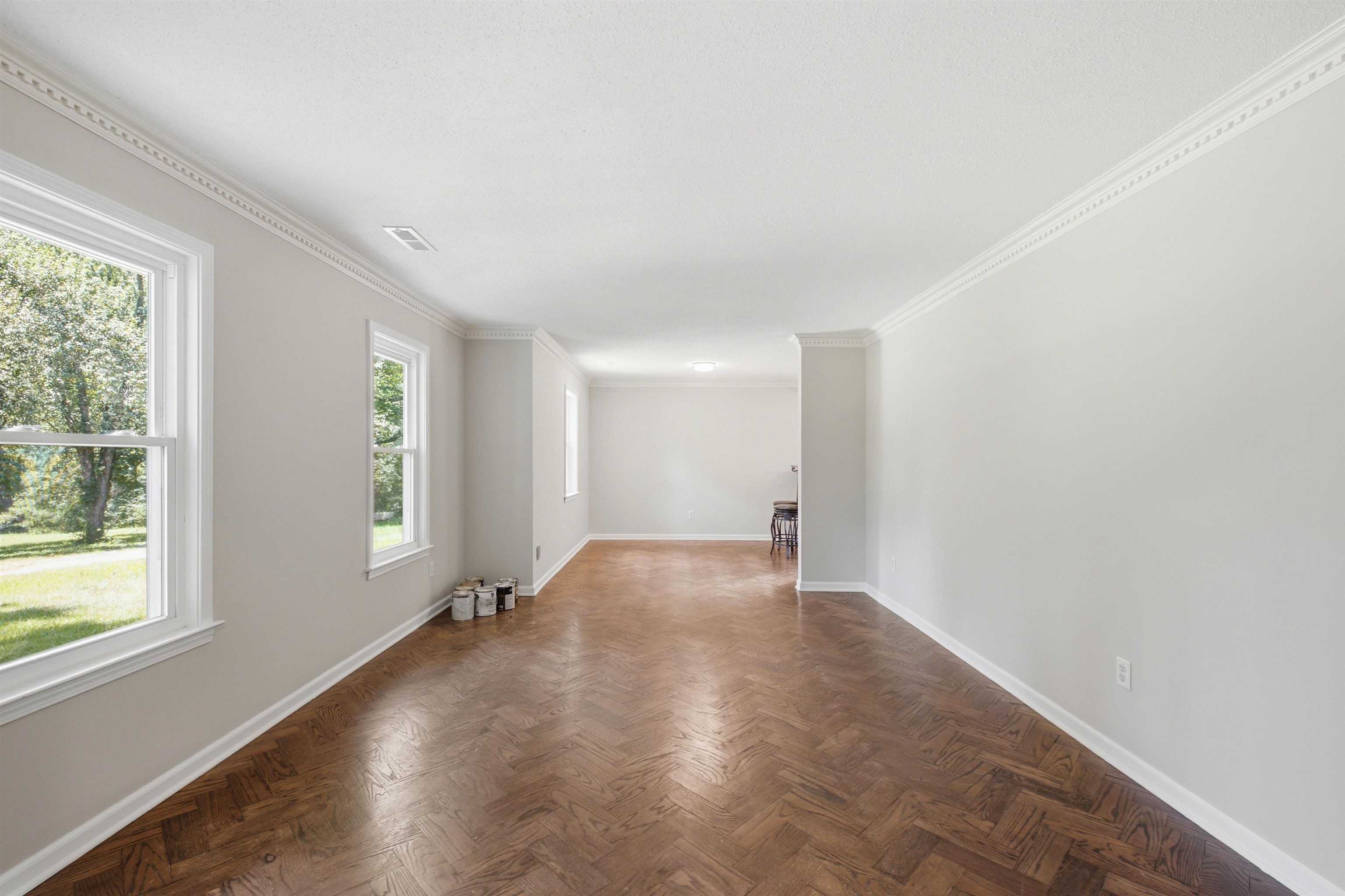 1370 North Reid Hooker Road Eads, TN 38028 - Photo 17 of 39 Spacious interior room featuring herringbone wood-finish flooring, white crown molding, and light-toned wall paint
