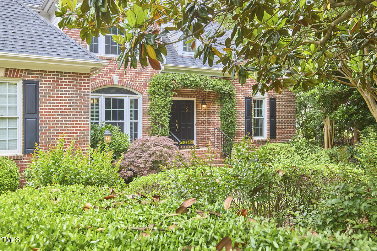 8605 Stanton Place Raleigh, NC 27615 - Photo 2 of 56 front view of a house with a small yard