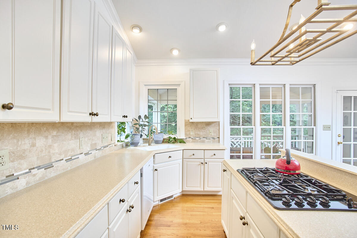 8605 Stanton Place Raleigh, NC 27615 - Photo 23 of 56 a large kitchen with stainless steel appliances granite countertop a sink stove and cabinets